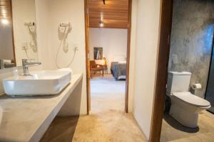 a bathroom with a sink and a toilet at Villaflor Pousada in Vale do Capao +127 photos