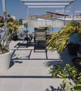 a patio with a chair and plants on a building at Trade winds International in Progreso