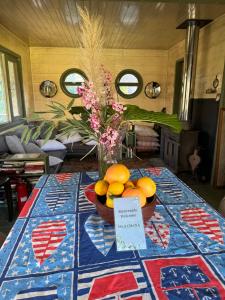 a table with a bowl of oranges and a vase of flowers at Isla Chaná Private Hideaway in Buenos Aires +25 photos