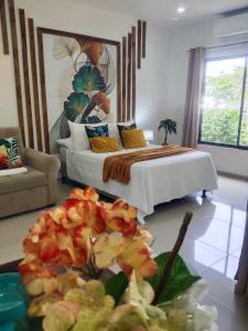 a bedroom with a bed and a table of food at Cabañas Mantas in Tárcoles
