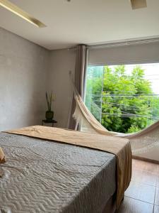 a bedroom with a bed and a large window at Loft Moderno I in Mossoró +21 photos