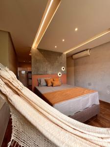 a bedroom with a bed with a hammock in it at Loft Moderno I in Mossoró