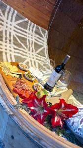 a table with a bottle of wine and glasses at Glampings Magic Bungalow in Villa de Leyva