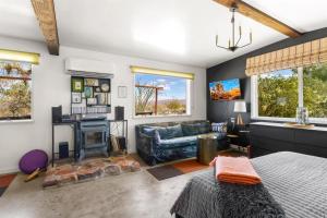 a living room with a bed and a fireplace at Cowboy Tubs, Zen Labyinth, Views, Quiet Serenity in Joshua Tree