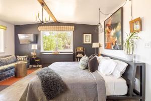 a bedroom with a bed and a living room at Cowboy Tubs, Zen Labyinth, Views, Quiet Serenity in Joshua Tree