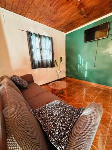 a living room with a couch and a flat screen tv at Sueño de Chicoana in Chicoana
