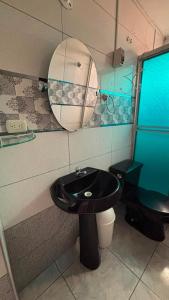 a bathroom with a black sink and a toilet at VillaHouse - Huaraz in Huaraz +14 photos