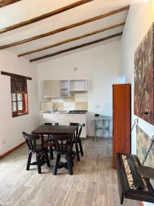 a dining room with a table and chairs and a kitchen at Glamping Store in Guatavita +26 photos