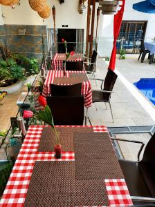 a table with a red and white checkered table cloth at hostal cf bed y breakfast in Cali