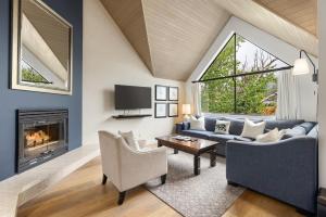 a living room with a couch and a fireplace at Powder's Edge by Whiski Jack in Whistler