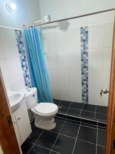 a bathroom with a toilet and a sink at Glamping Store in Guatavita