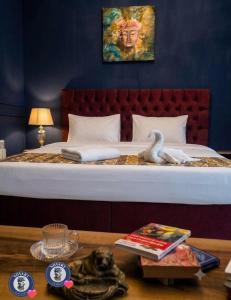 a bedroom with a bed with a swan on it at Caspian Seaside Hotel in Sumqayıt