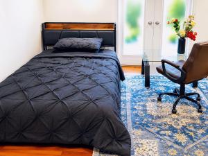 a bedroom with a bed and a desk and a chair at Your own home in Toronto