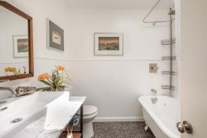 a white bathroom with a tub and a sink at Cowboy Tubs, Zen Labyinth, Views, Quiet Serenity in Joshua Tree +127 photos
