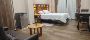 a hotel room with a bed and a table at Hotel Central in Cochabamba +3 photos