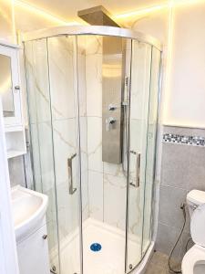 a shower with a glass door in a bathroom at Your own home in Toronto +12 photos