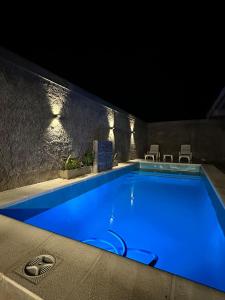 a swimming pool at night with blue water at Sueño de Chicoana in Chicoana +4 photos