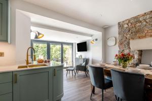 a kitchen and dining room with a stone wall at 2 Bed in Tenby oc-b41402 in Tenby