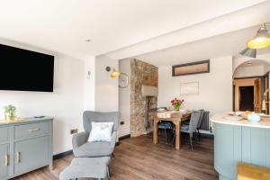 a kitchen and living room with a table and chairs at 2 Bed in Tenby oc-b41402 in Tenby