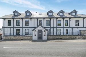 a large white house with a large roof at 2 Bed in Tenby oc-b41402 in Tenby