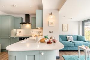 a kitchen and living room with a blue couch at 2 Bed in Tenby oc-b41400 in Tenby +12 photos