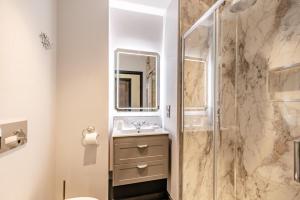 a bathroom with a shower and a sink at 2 Bed in Tenby oc-b41400 in Tenby