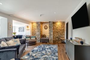 a living room with a couch and a flat screen tv at 2 Bed in Tenby oc-b41399 in Tenby