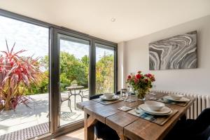 a dining room with a wooden table and a large window at 2 Bed in Tenby oc-b41399 in Tenby