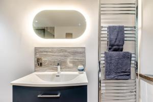a bathroom with a sink and a mirror at 2 Bed in Tenby oc-b41399 in Tenby +17 photos