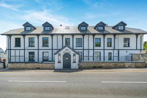 a large white house with a black roof at 2 Bed in Tenby oc-b41399 in Tenby