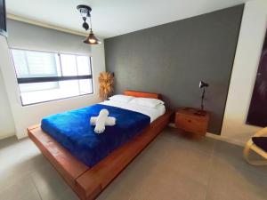 a bedroom with a bed with a teddy bear on it at GURUS FR | Cómodo Elegante cerca Termales in Santa Rosa de Cabal
