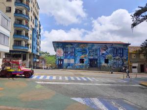 a building with a mural on it on a city street at GURUS FR | Cómodo Elegante cerca Termales in Santa Rosa de Cabal