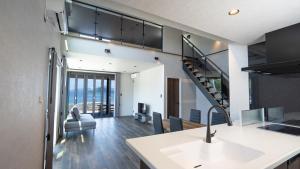 a kitchen and living room with a view of the ocean at LIFEMENT GLANZ Okimi in Etajima