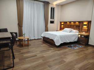 a bedroom with a bed and a desk and a piano at Hotel Central in Cochabamba