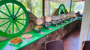 a table with pots and pans on it next to a wheel at Seravelle Adventure Camping in Kitulgala