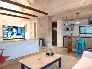 a living room with a couch and a table at La Choza - Refugio para dos in La Falda