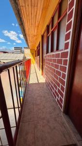 a balcony with a brick wall and a wooden ceiling at VillaHouse - Huaraz in Huaraz