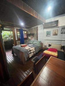 a bedroom with two beds and a table at Chalé Bambu in Cunha