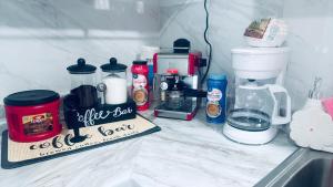 a kitchen counter with a coffee pot and a coffee maker at Private Miami Suite in Tamiami Airport +8 photos