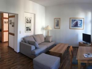 a living room with a couch and a table at Courtyard Idyll Apartment in Rostock