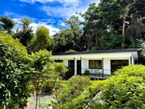 a house in the middle of a garden at Monteverde Magic Mountain Lodge in Monteverde Costa Rica