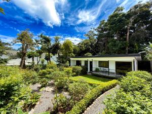 a house with a garden in front of it at Monteverde Magic Mountain Lodge in Monteverde Costa Rica
