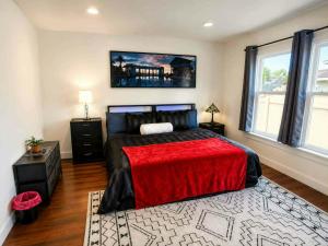 a bedroom with a large bed with a red blanket at The Victorian House in Buffalo