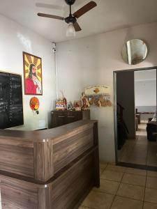 a bar in a restaurant with a ceiling fan at ''Pousada Rosa Amiga'' in Barretos