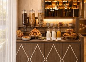 a buffet with food and drinks on a table at Hotel Maison Lenoir in Paris