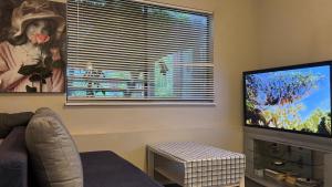 a living room with a large flat screen tv at Love Capilano in North Vancouver