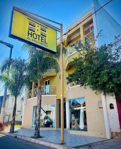 a hotel sign in front of a building at Hotel el Progreso in Olta +3 photos