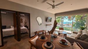 a living room with a table and a couch at El Xalli Hotel in El Zonte
