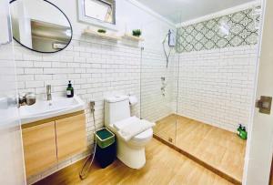 a bathroom with a toilet and a sink and a mirror at Secret Palm in Ko Phangan