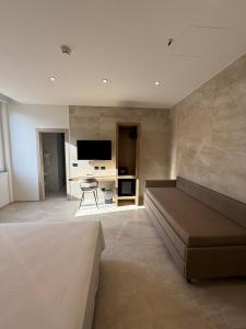 a living room with a couch and a television at Hotel Corona in Termoli